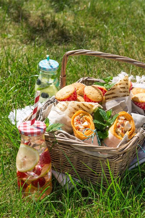 Picnic Basket With Food On Green Sunny Lawn Featuring Picnic Basket
