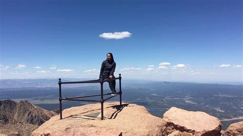 Cycling on a paved road above 14. Summit Pikes Peak 14,115 ft elevation world famous peak ...