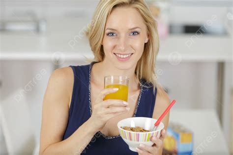 A Smiling Woman Eating Breakfast Photo Background And Picture For Free