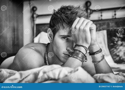 Shirtless Male Model Lying Alone On His Bed Stock Photo Image