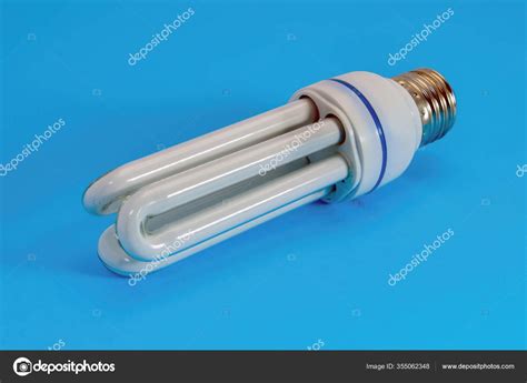 Compact Fluorescent Energy Saving Light Bulb Isolated Blue Background