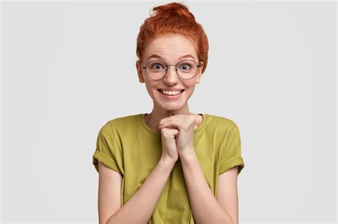Free Photo Happy Freckled Redhead Woman With Positive Smile Keeps