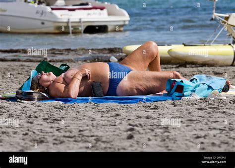 Obese Lady Sunbathing On The Beach In Spain Stock Photo Alamy