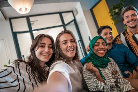 group of business people during break from the work taking selfie picture while enjoying free