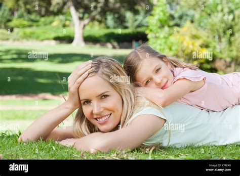 Mother With Her Hand On Her Head As Her Daughter Rests On Her Mothers