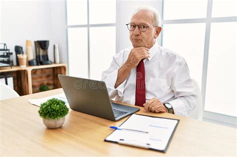 Senior Man Working At The Office Using Computer Laptop Thinking