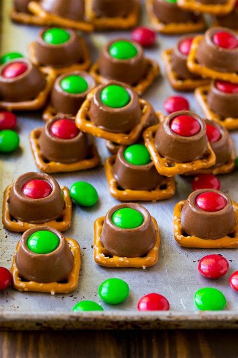 Rolo Pretzels On A Baking Sheet Topped With Red And Green Mandms