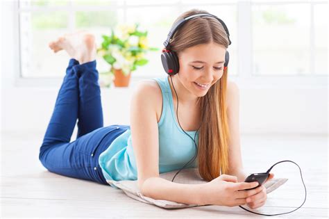 Relaxing With Her Favorite Music Cheerful Teenage Girl In Headphones