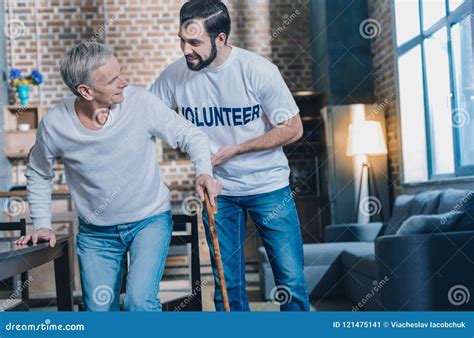 Kind Cheerful Man Helping An Aged Man Stock Image Image Of Community Healthcare 121475141