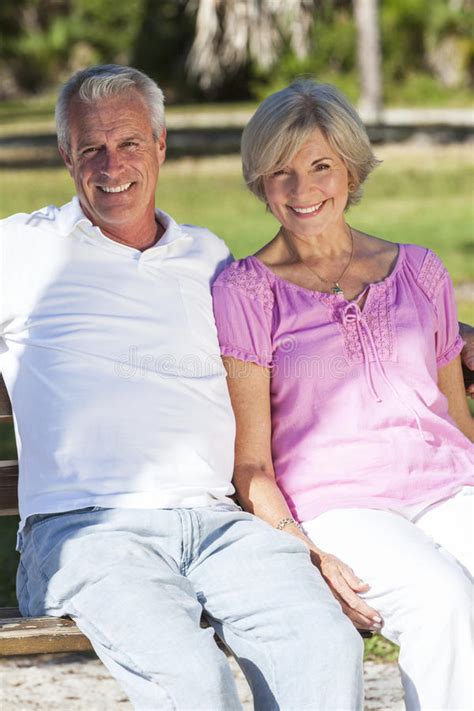 Happy Senior Couple Sitting On Bench In Sunshine Stock Photo Image Of
