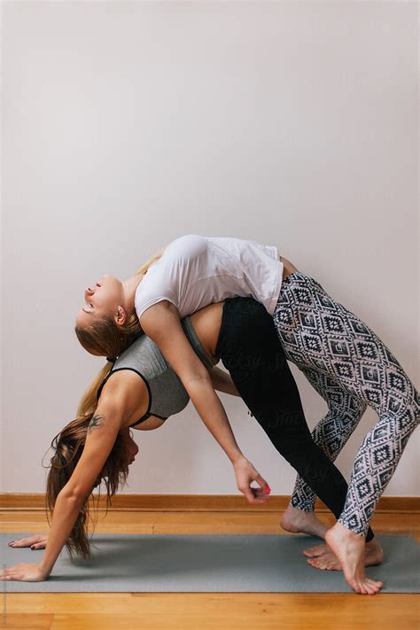 Two Women Doing Yoga Together By Marija Kovac