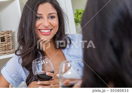 Beautiful Hispanic Latina Woman Drinking Wine With A Friend