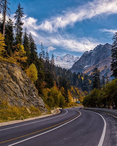 Landscape Photography Of Road Between Mountain And Trees · Free Stock Photo