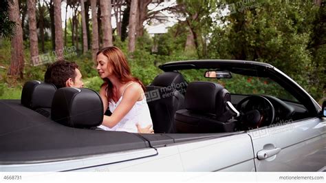 Adjust the car seat if the kiss gets more intense. Woman Kissing Her Boyfriend In A Convertible Car Stock ...