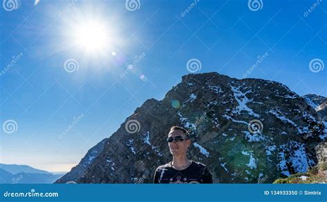 Man On The Background Of Peak Of The Achisho Mountain Covered By Snow