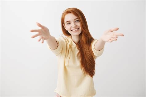 Free Photo Gorgeous Smiling Redhead Girl Reaching Hands Forward To