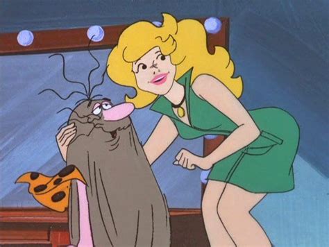 a woman in a green dress standing next to a cat and looking at it s face