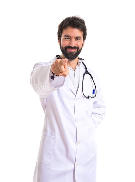 Free Photo Doctor Pointing To The Front Over White Background