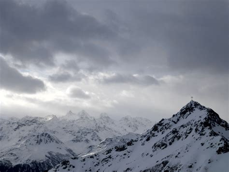 Cross On Top Of Snowy Mountain Under Dark Cloudy Sky Free Image Peakpx