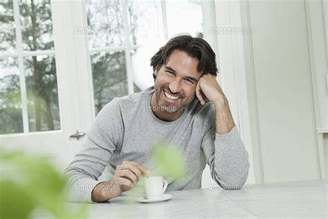Germany Berlin Mature Man With Coffee Cup Smiling Portra