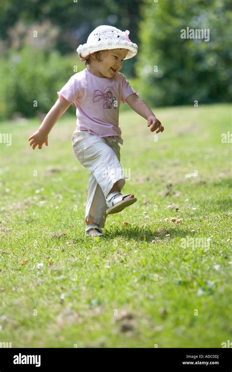 Little Girl With A Hat Dancing In The Parc Stock Photo Alamy