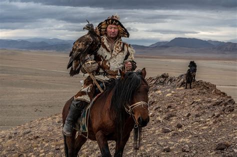 Kazakh Eagle Hunter And Horseman Alankush Trains His Eagle In The Altai