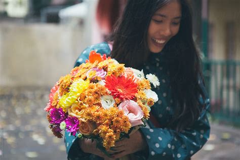 Asian Woman With Flowers Outdoors Del Colaborador De Stocksy Lumina Stocksy
