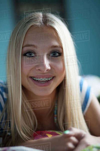 Close Up Of Smiling Teenage Girl With Long Blonde Hair And Braces