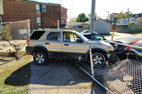 Car In Toronto Goes Through Stop Sign Fence And Crashes Into Parked