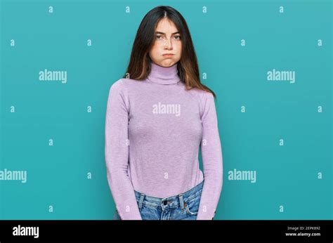 Young Beautiful Teen Girl Wearing Turtleneck Sweater Puffing Cheeks