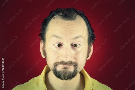 A Funny Ugly Man With His Eyes Crossed Vignette Red Background Close Up Shot Stock Foto