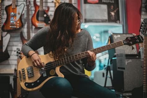 Woman Playing Bass Guitar · Free Stock Photo