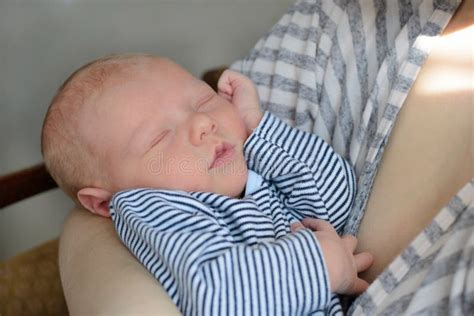 Newborn Baby Sleeps In The Arms Of His Mother Stock Photo Image Of