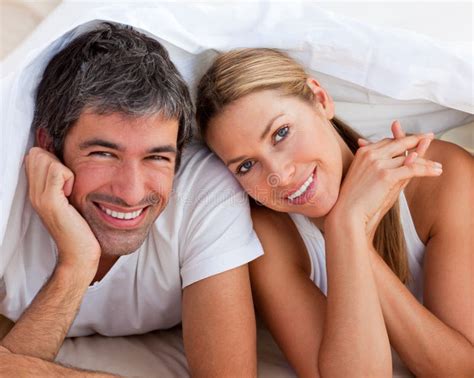 Enamoured Couple Having Fun Lying On Bed Stock Image Image Of