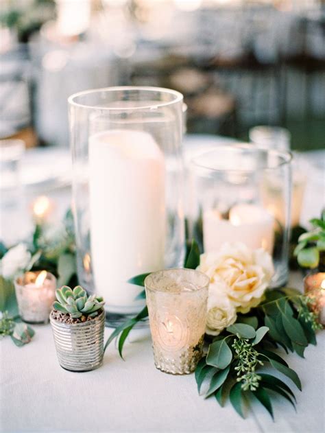 Trios Of Thick Pillar Candles At Varied Heights With Clusters Of
