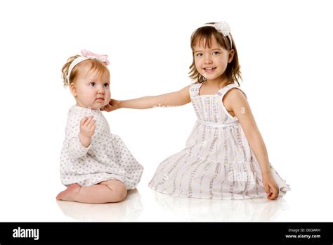 Two Little Sisters Playing Together Isolated On White Stock Photo Alamy