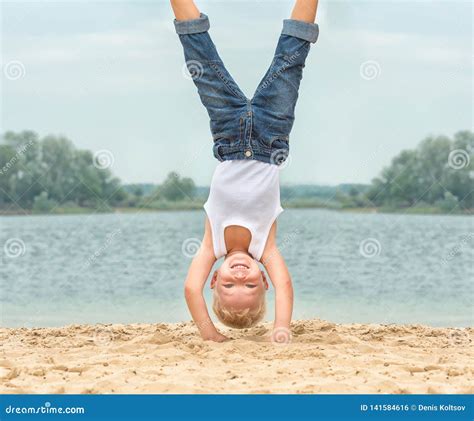 Little Boy Doing A Handstand On The Beachsummer Recreation And Sports