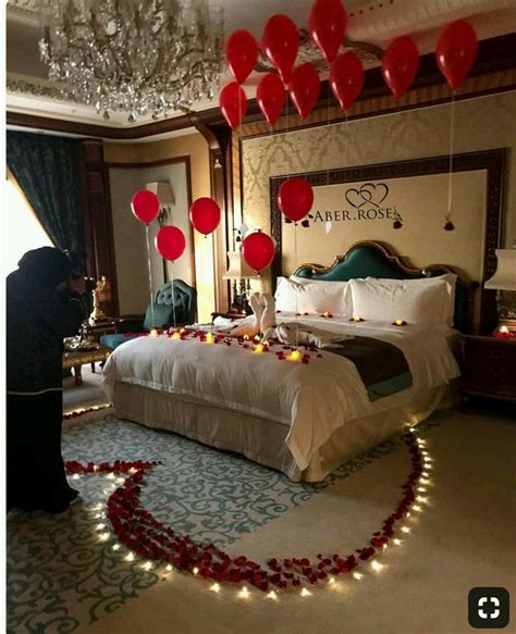 A Bedroom Decorated For Valentine S Day With Red Balloons