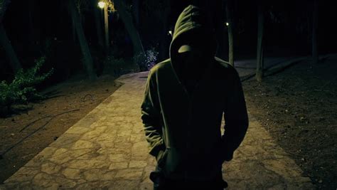Guy with bristle in dark grey and black hoodie. Suspicious Hooded Figure Walks In A Dark Park At Night ...