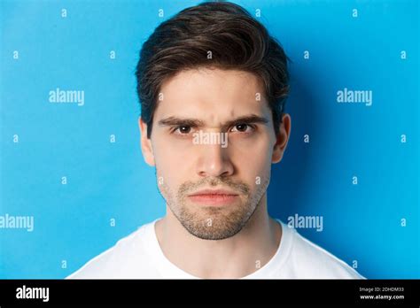 Headshot Of Angry Man Frowning Looking Disappointed And Bothered