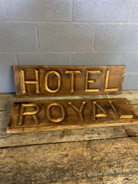 A Large Gilt Lettered Carved Wooden Hotel Sign Belle And Beast Emporium