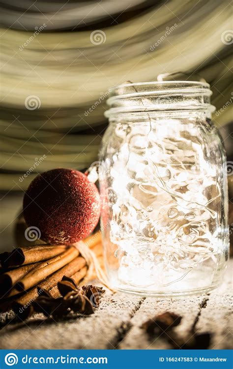 Christmas Setting With Bundle Of Cinnamon Jar With Lights Anise Stars