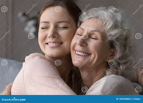 Happy Elderly Mother And Senior Daughter Hug And Cuddle Stock Photo Image Of Offspring Care