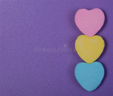 Colorful Hearts Three Sweetheart Candy Over Purple Background Stock