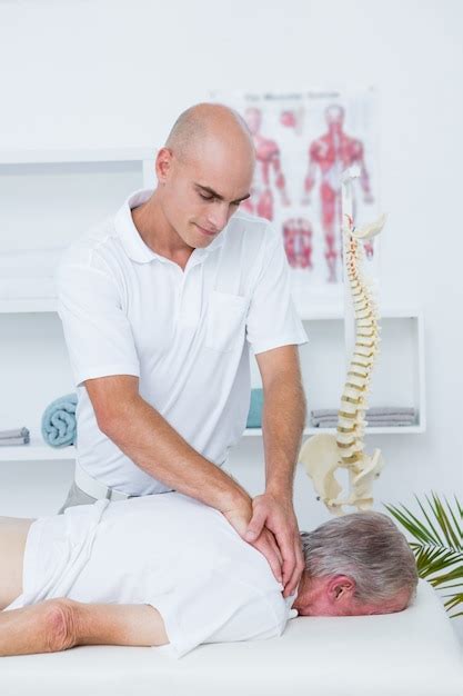 Premium Photo Physiotherapist Doing Neck Massage To His Patient