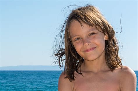 A Beautiful Girl Posing On A Beach By The Sea Stock Photo Download