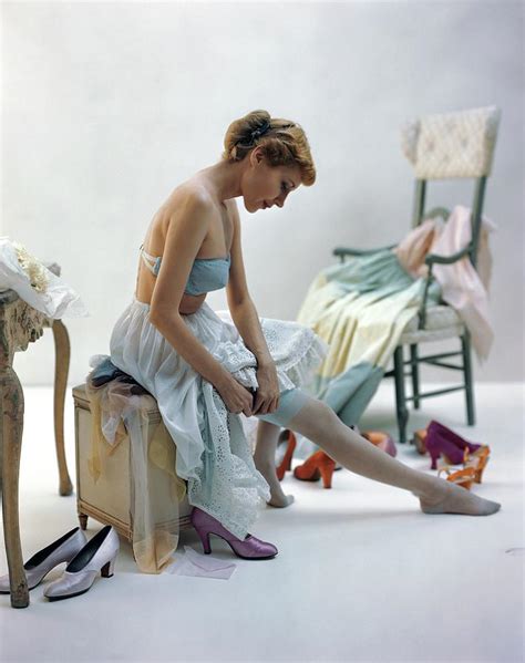 A Woman Putting On Her Stockings Photograph By John Rawlings Fine Art America