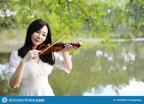 Young Woman Dedicated Playing Violin Silhouette Of Teenage Violin