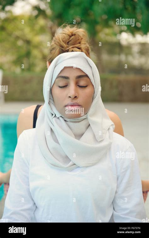 Woman Doing Yoga By The Poolside In Dubai Stock Photo Alamy