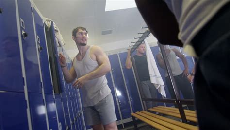 4k cheerful sports players or gym buddies chatting together in men s locker room stock footage
